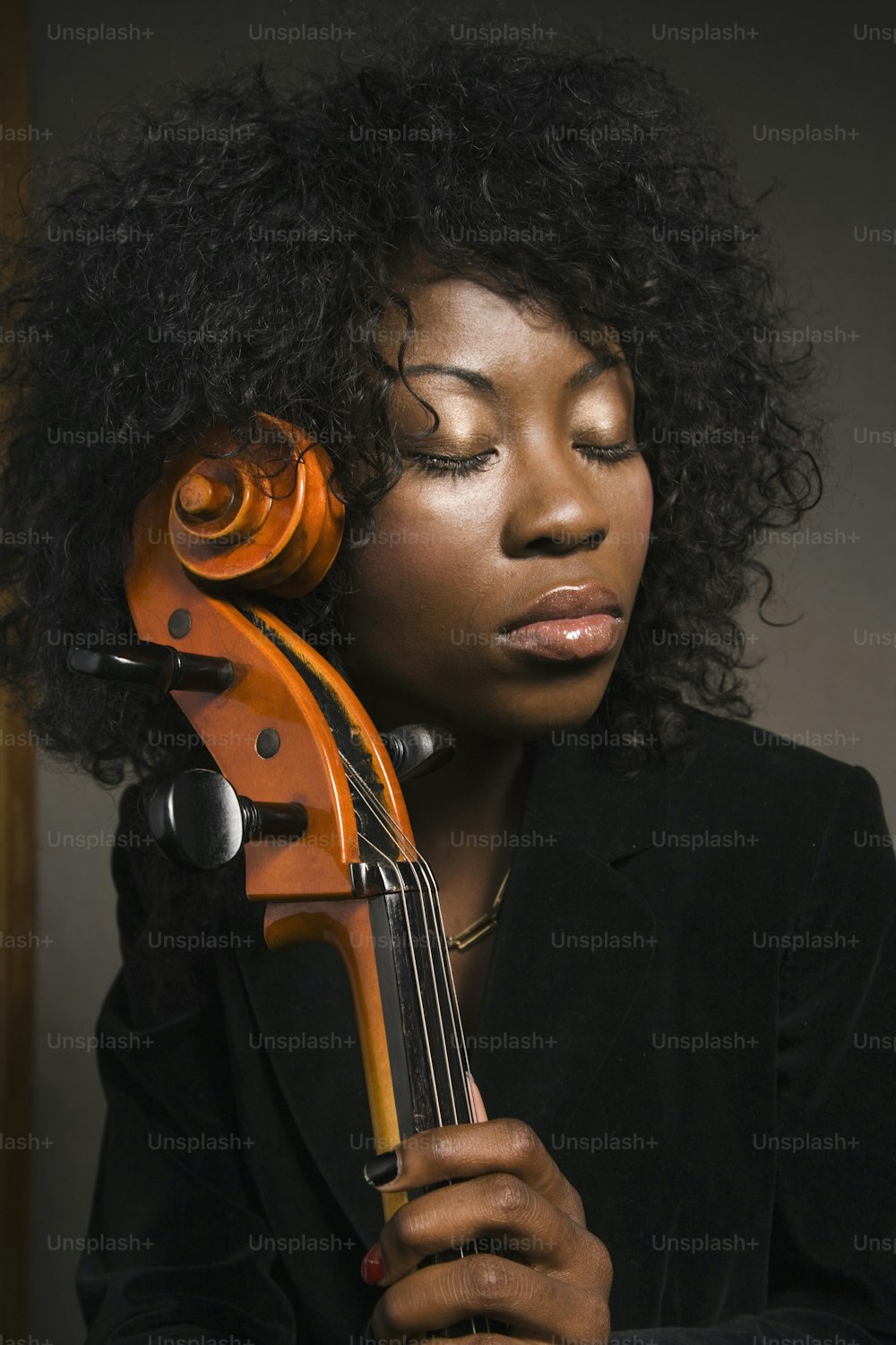a woman with curly hair holding a violin