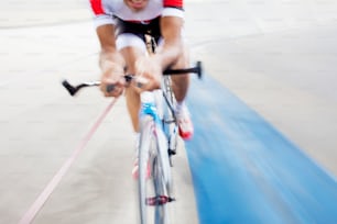 a man riding a bike down a track