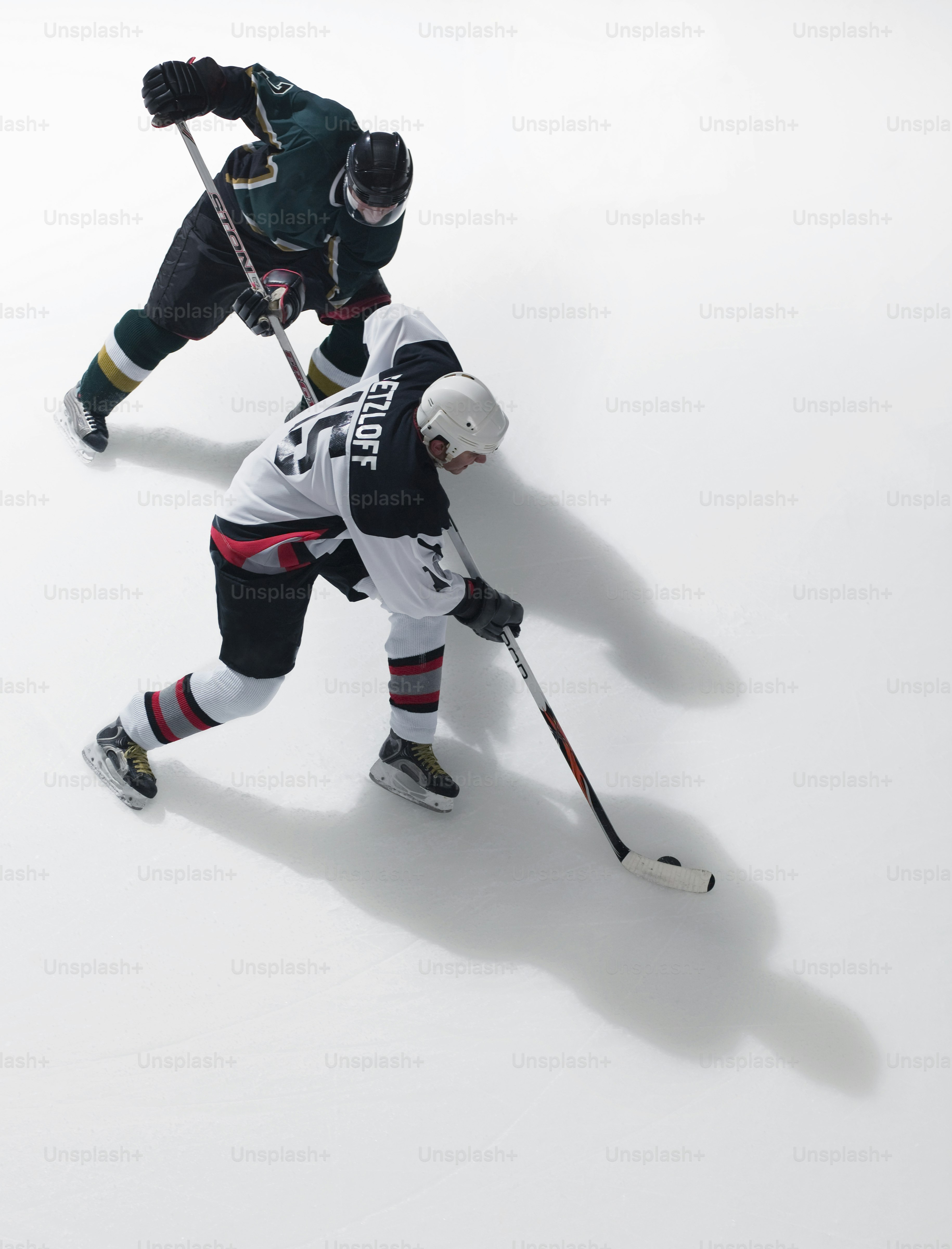 a couple of men playing a game of ice hockey