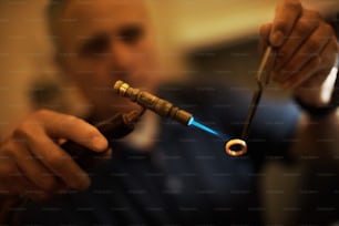 a man holding a pipe with a blue light coming out of it
