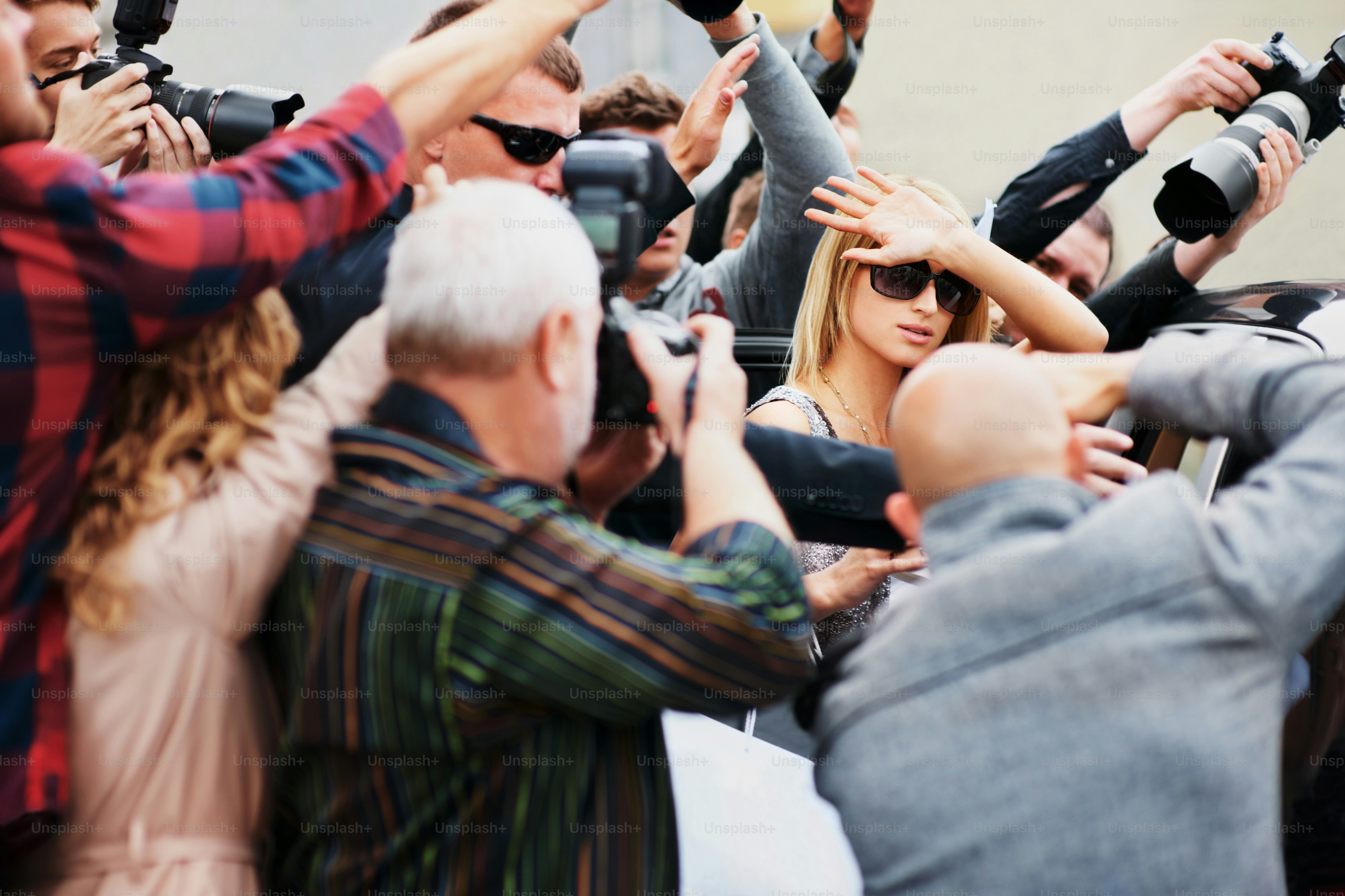 a group of people standing around each other