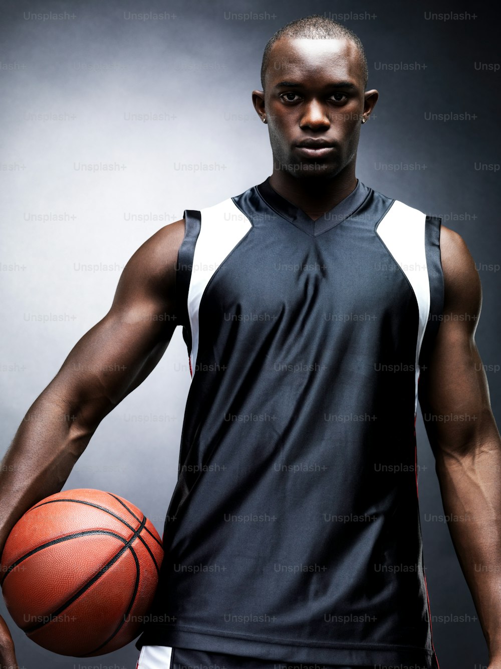 a man holding a basketball in his right hand