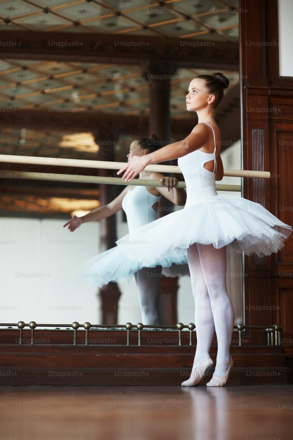 two ballerinas in white tutus and ballet shoes