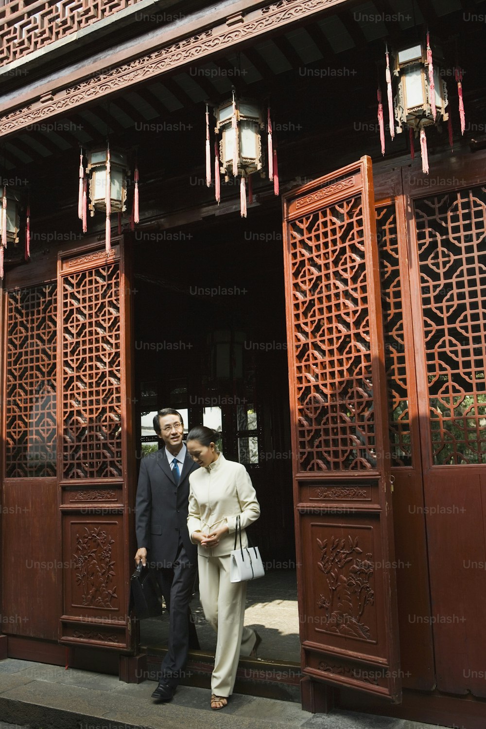 a man and a woman standing outside of a building
