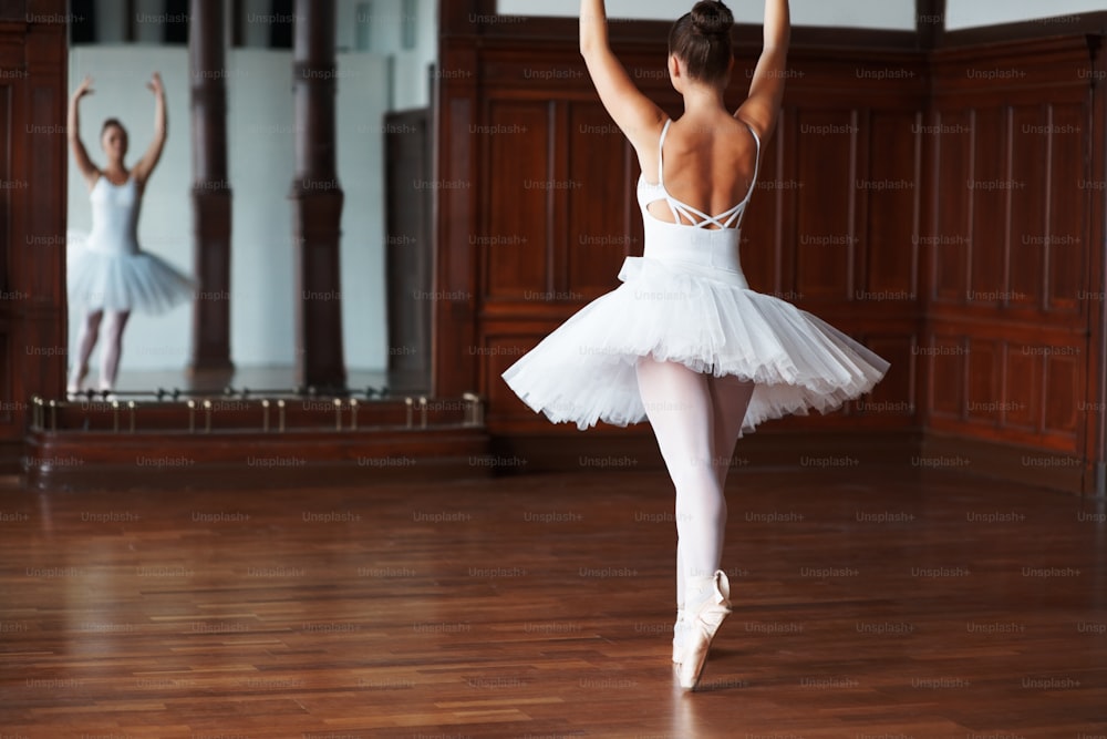 a ballerina in a white tutu and a ballerina in a white dress