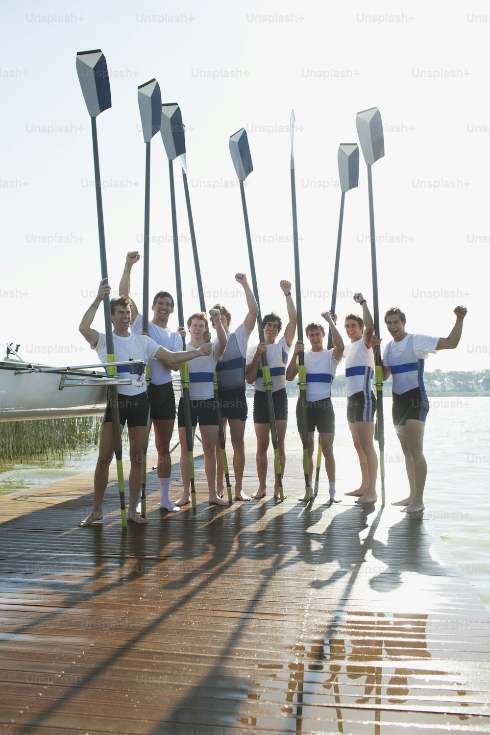 a group of people standing on top of a wooden pier