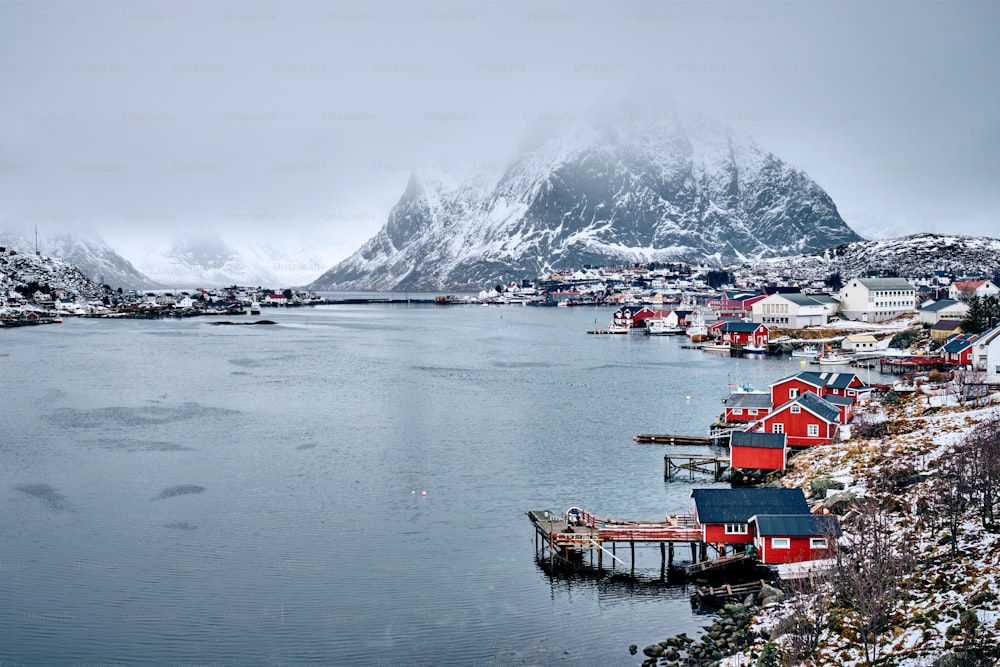 Reine fishing village on Lofoten islands with red rorbu houses in winter with snow. Lofoten islands, Norway