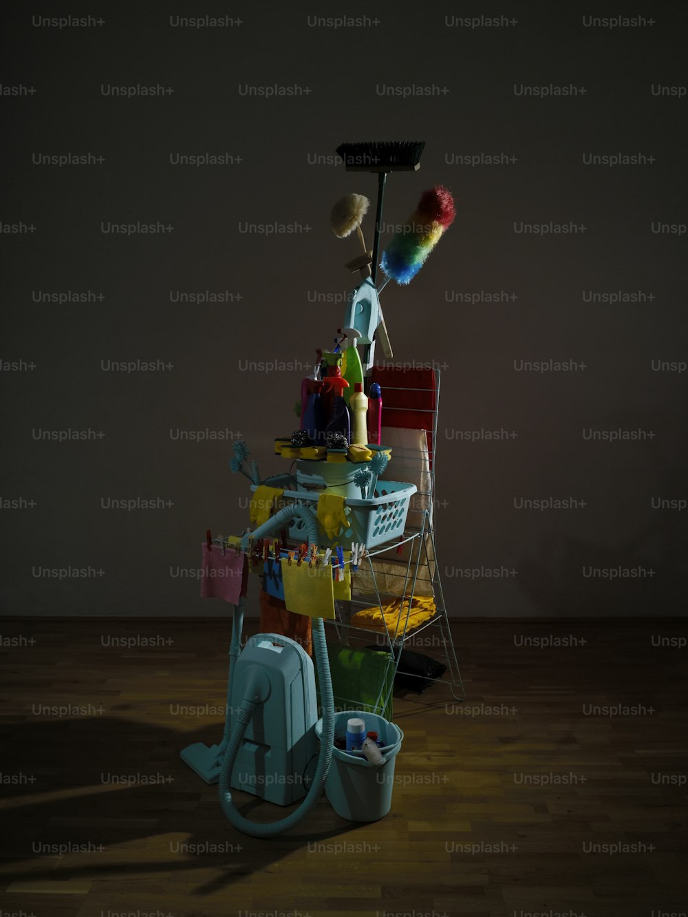 a pile of cleaning supplies sitting on top of a wooden floor
