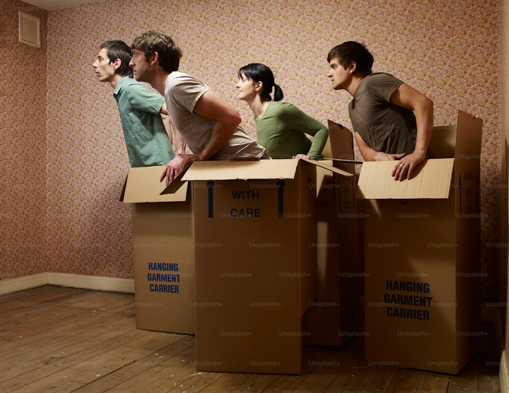 a group of people sitting on top of cardboard boxes