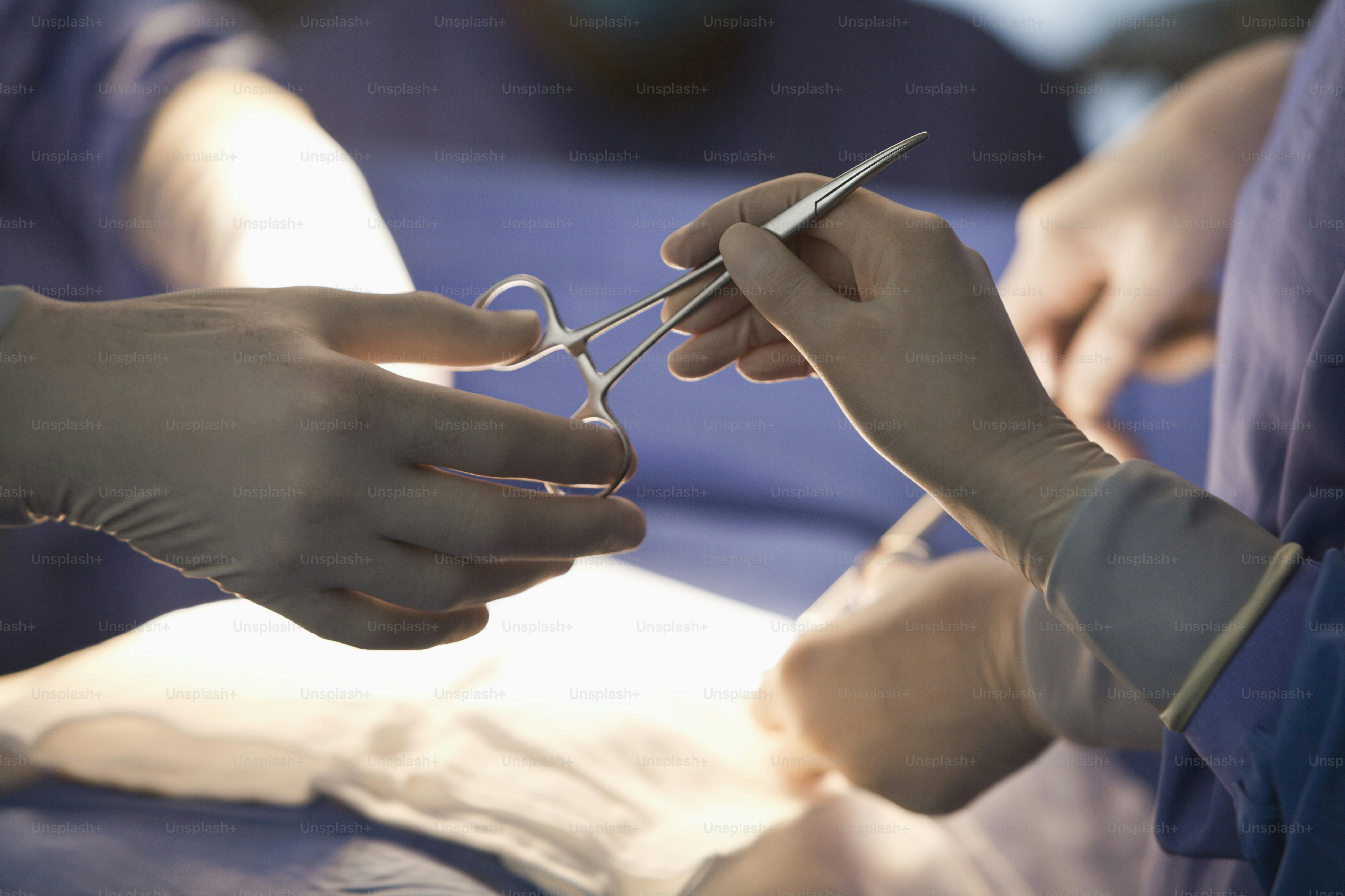 a pair of hands holding a pair of scissors