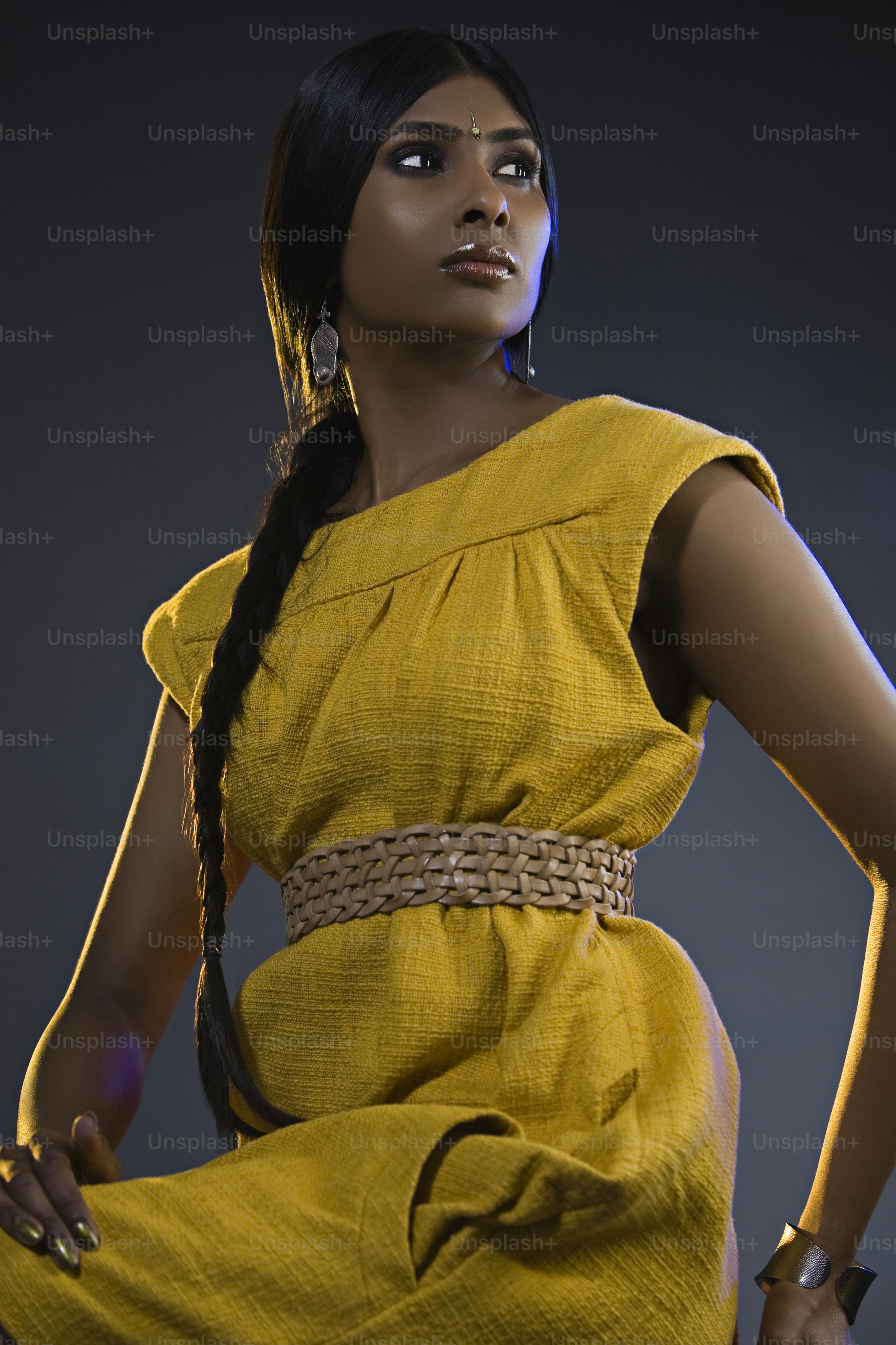 a woman in a yellow dress posing for a picture