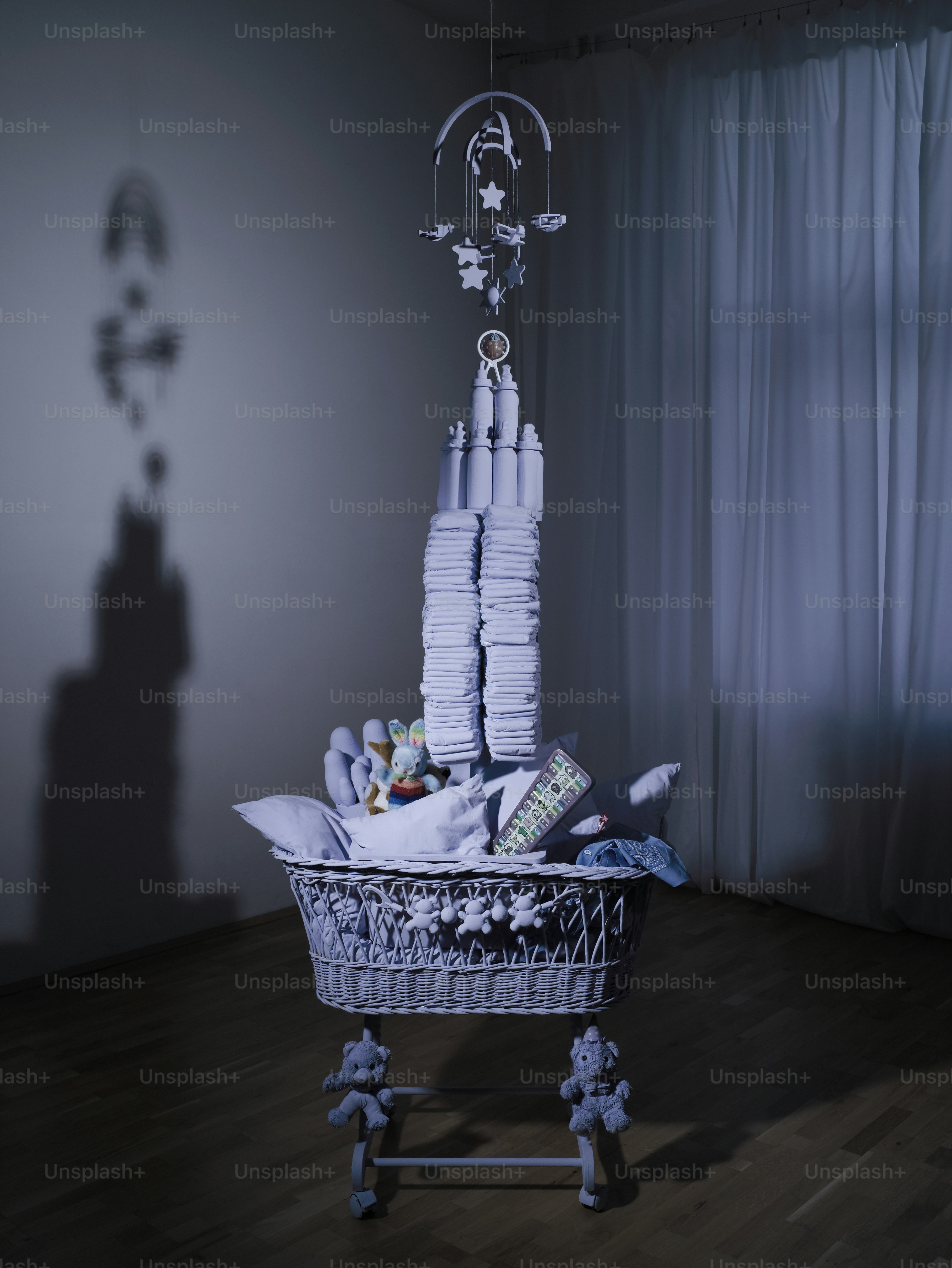 a basket filled with lots of diapers sitting on top of a wooden floor