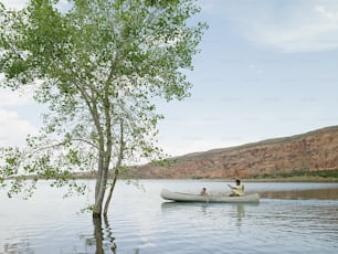 two people in a canoe on a lake