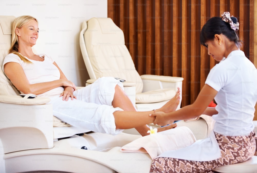 Mature woman receives a calming pedicure at the spa