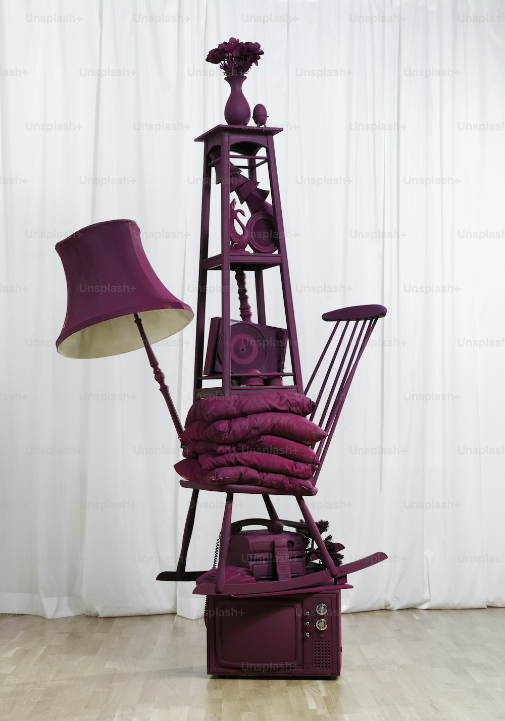 a purple sculpture with a lamp on top of it