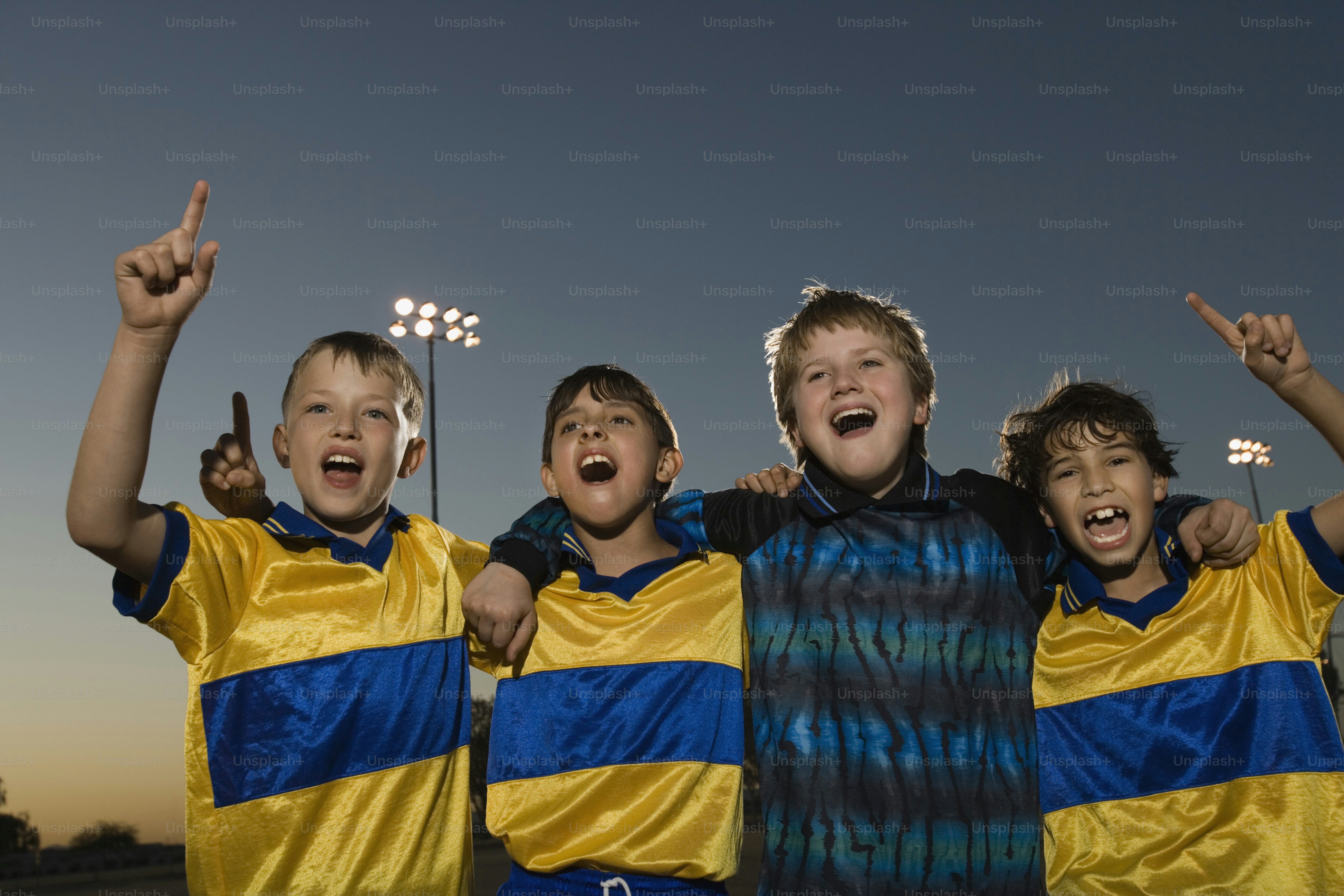 a group of young boys standing next to each other