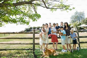 a group of people standing next to a dog