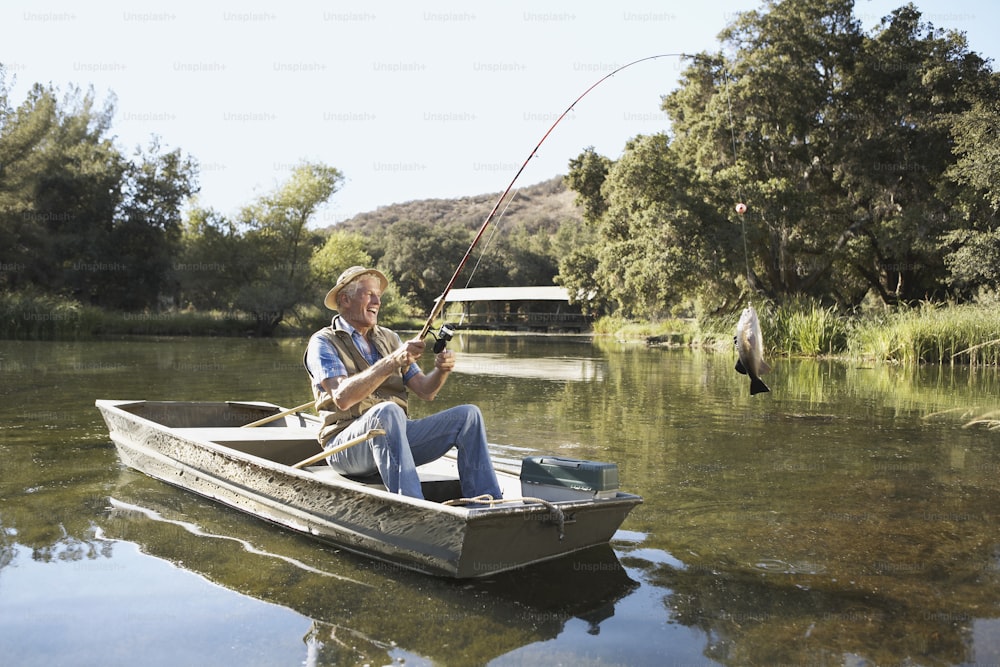 a man sitting in a boat with a fishing rod