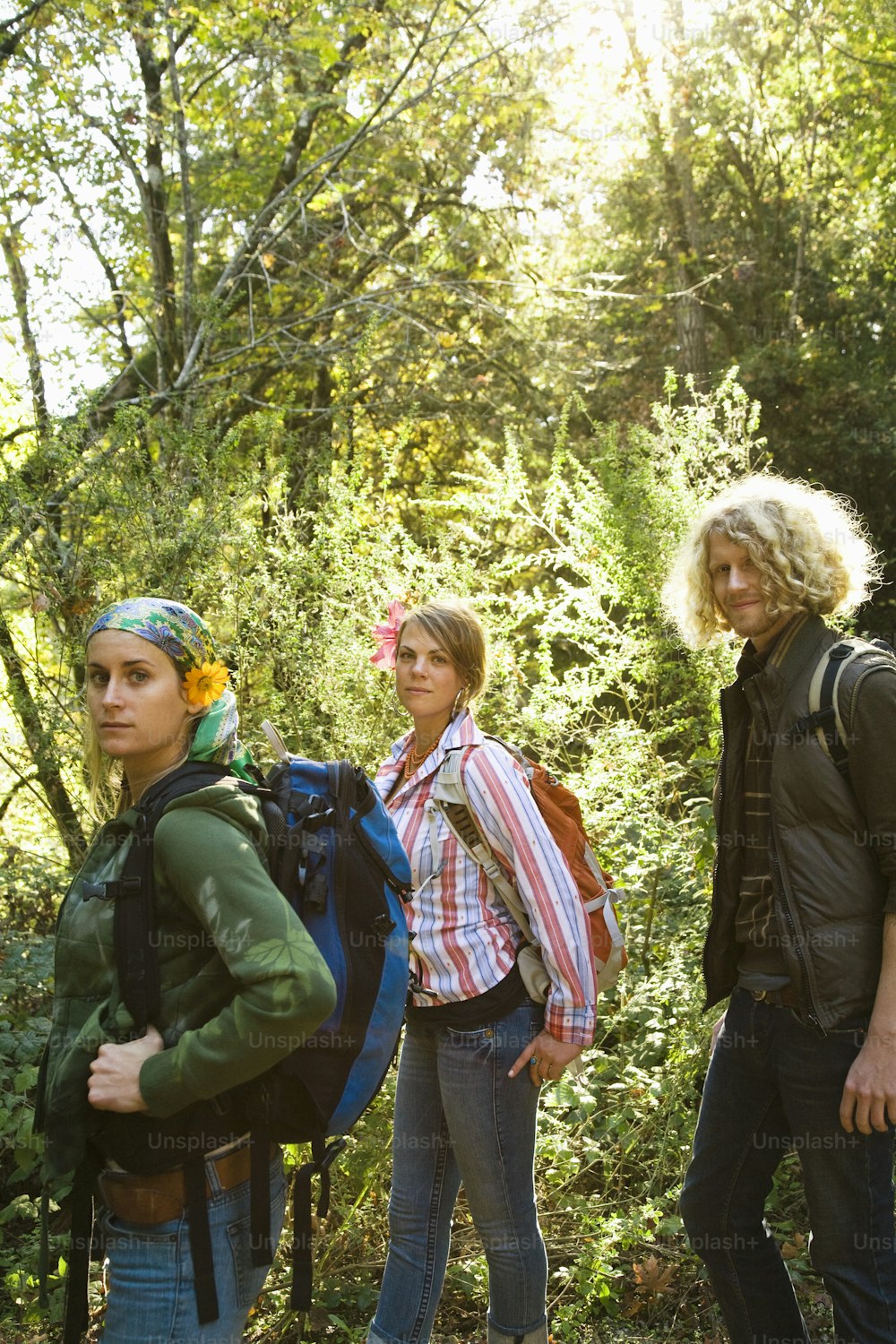 a group of people standing next to each other in the woods