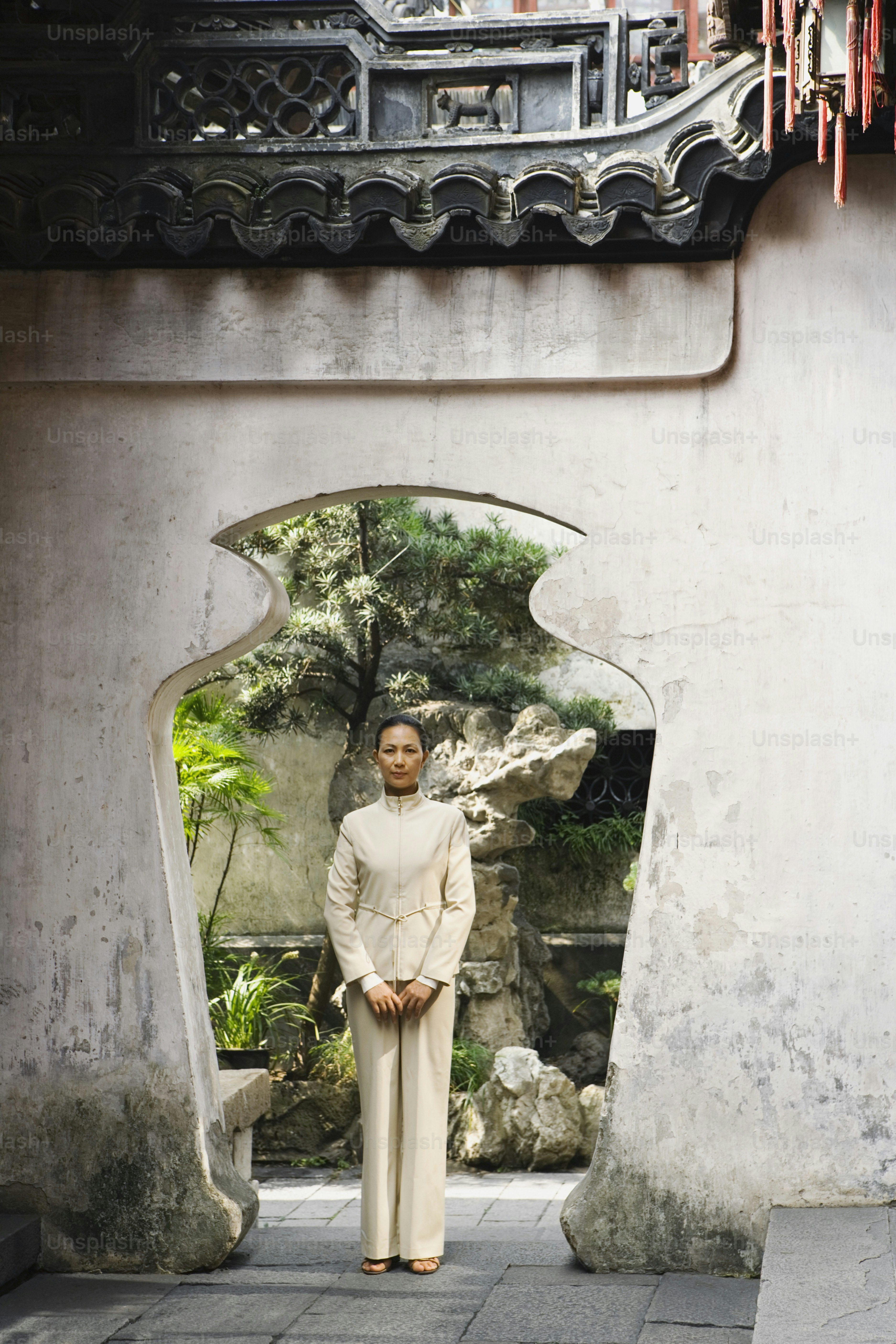 a woman in a white outfit standing in a doorway