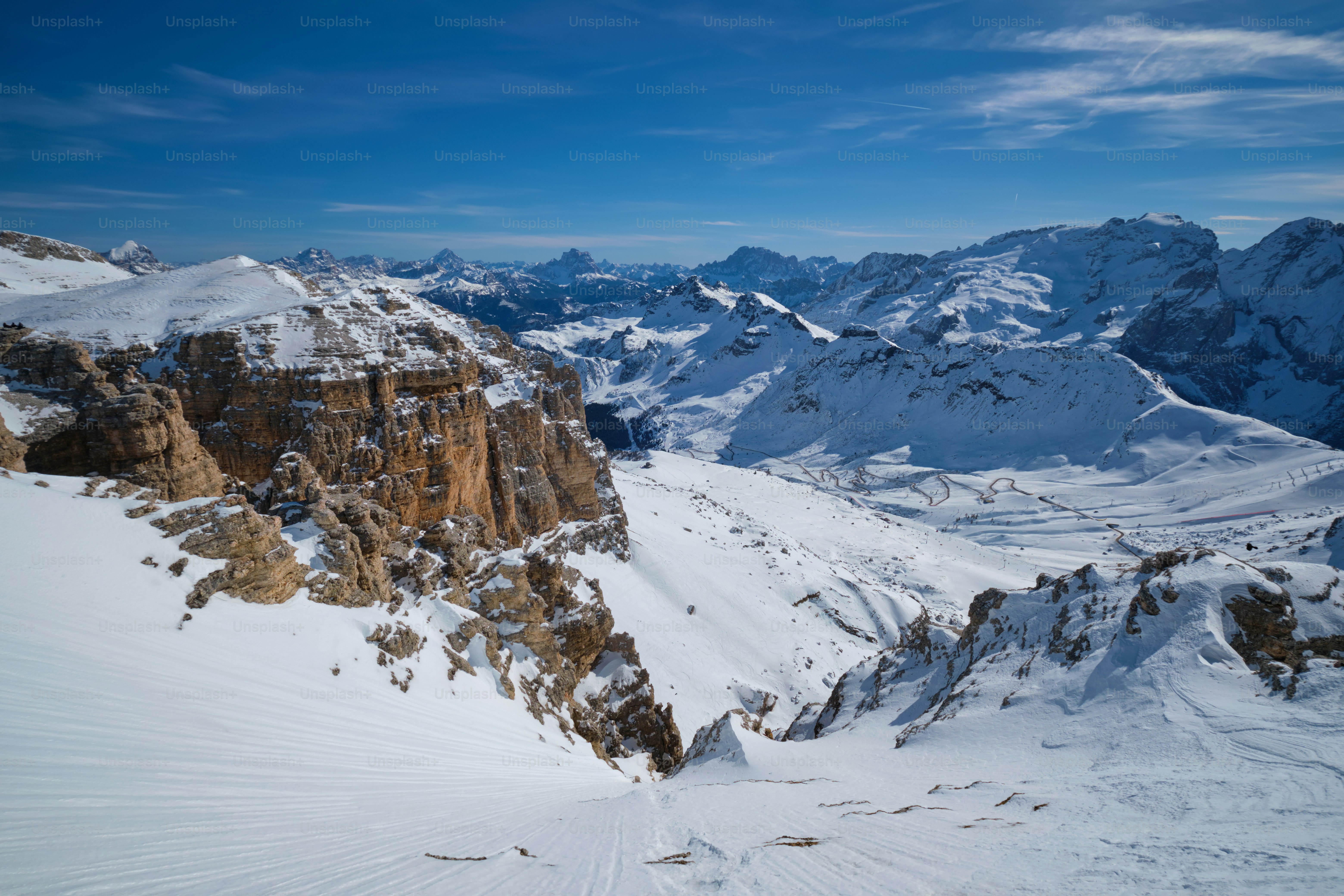 View of a ski resort piste and Dolomites mountains in Italy from Passo Pordoi pass. Arabba, Italy