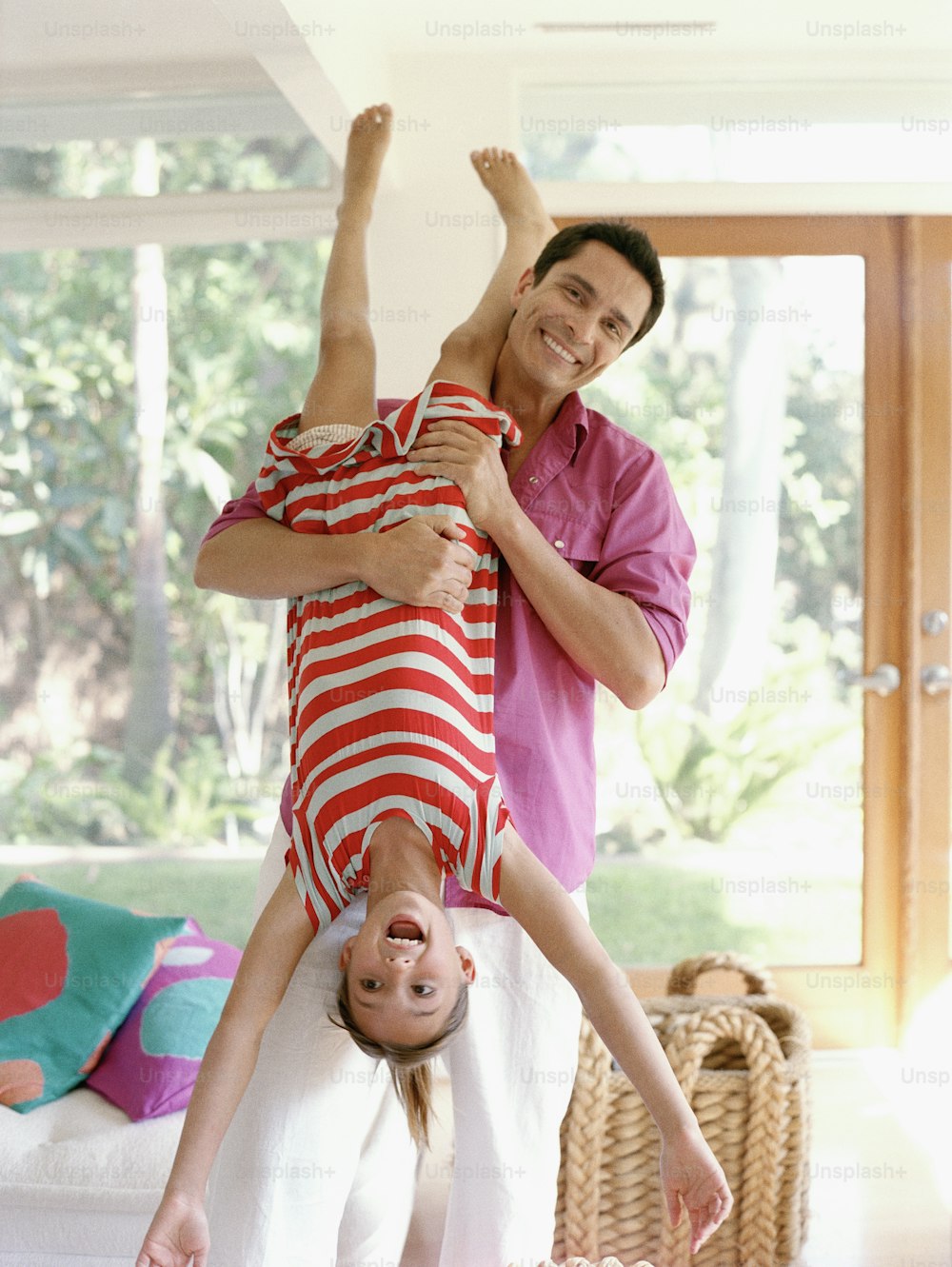 a man and a little girl doing a handstand