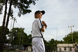 Ritratto di giovane giocatore di baseball con campo sullo sfondo