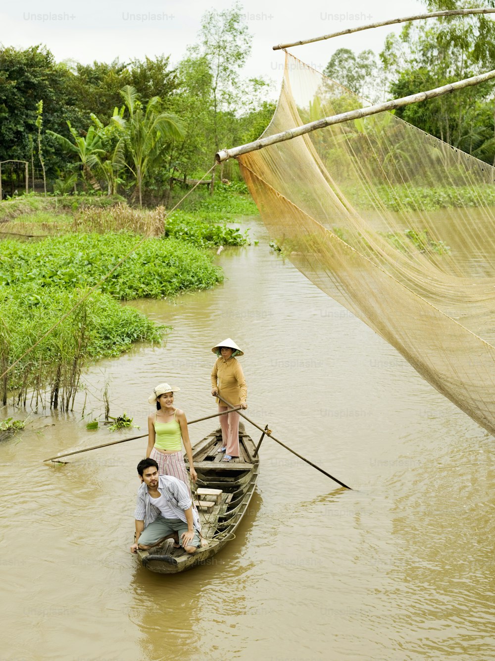 a group of people riding on top of a boat in a river