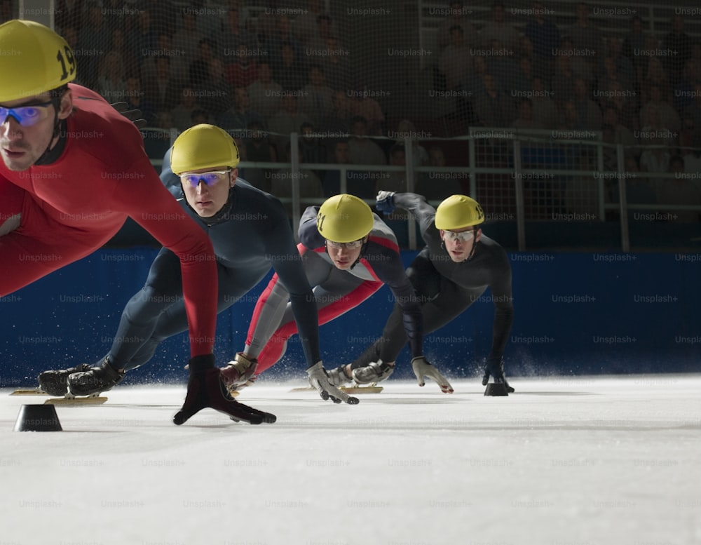 Un groupe d’hommes sur des planches à roulettes sur une pente enneigée