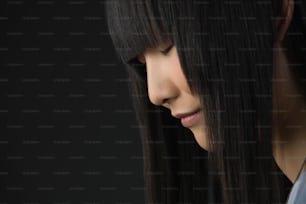 a close up of a woman with long black hair