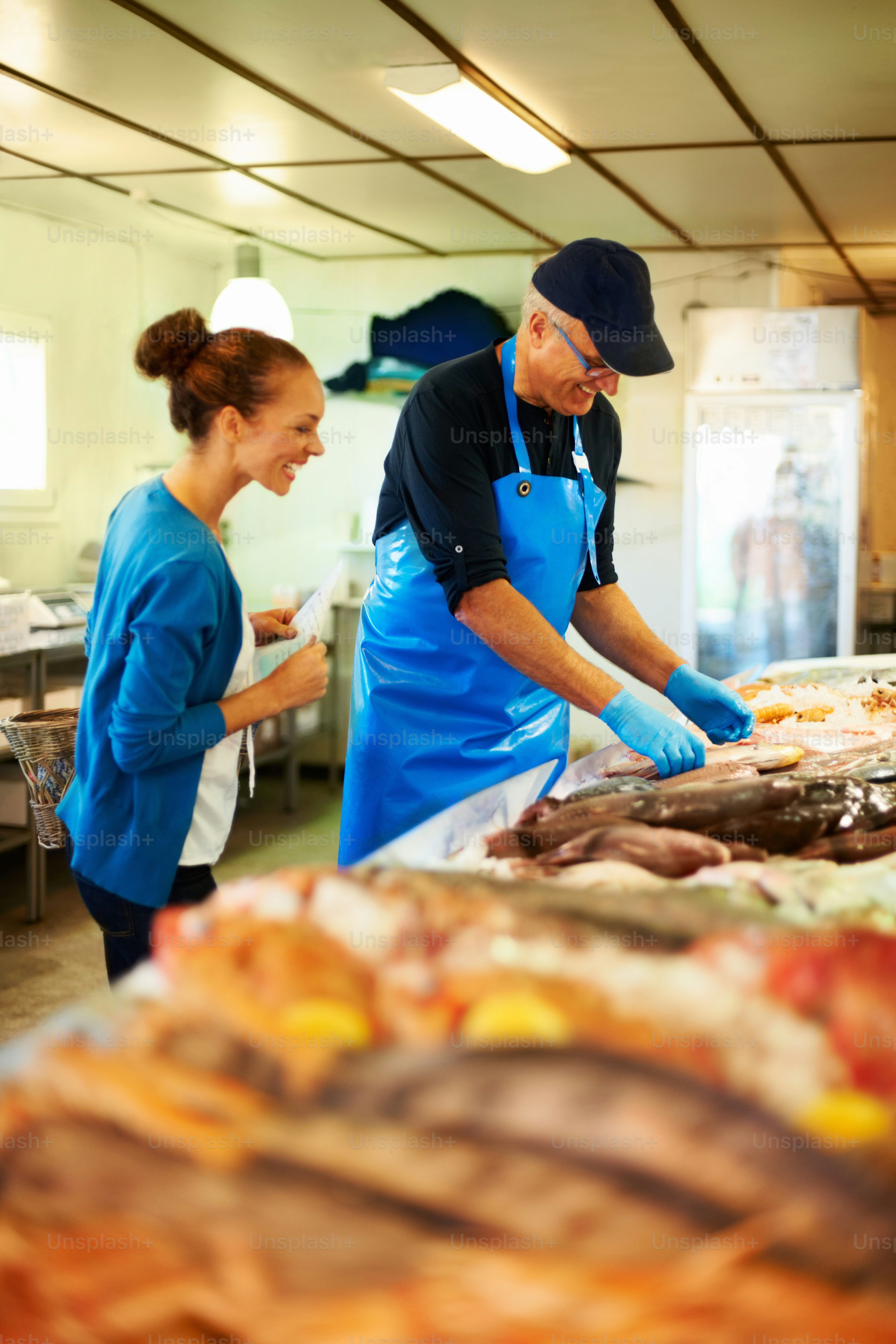 a man and a woman working in a kitchen