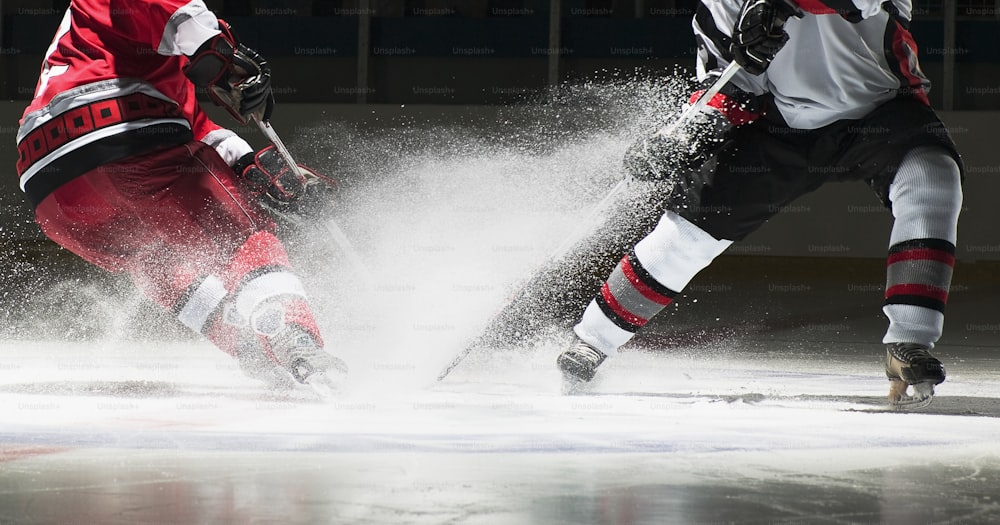 a couple of men playing a game of ice hockey