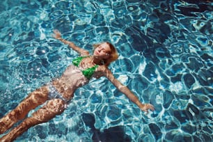 a woman floating in a pool of water