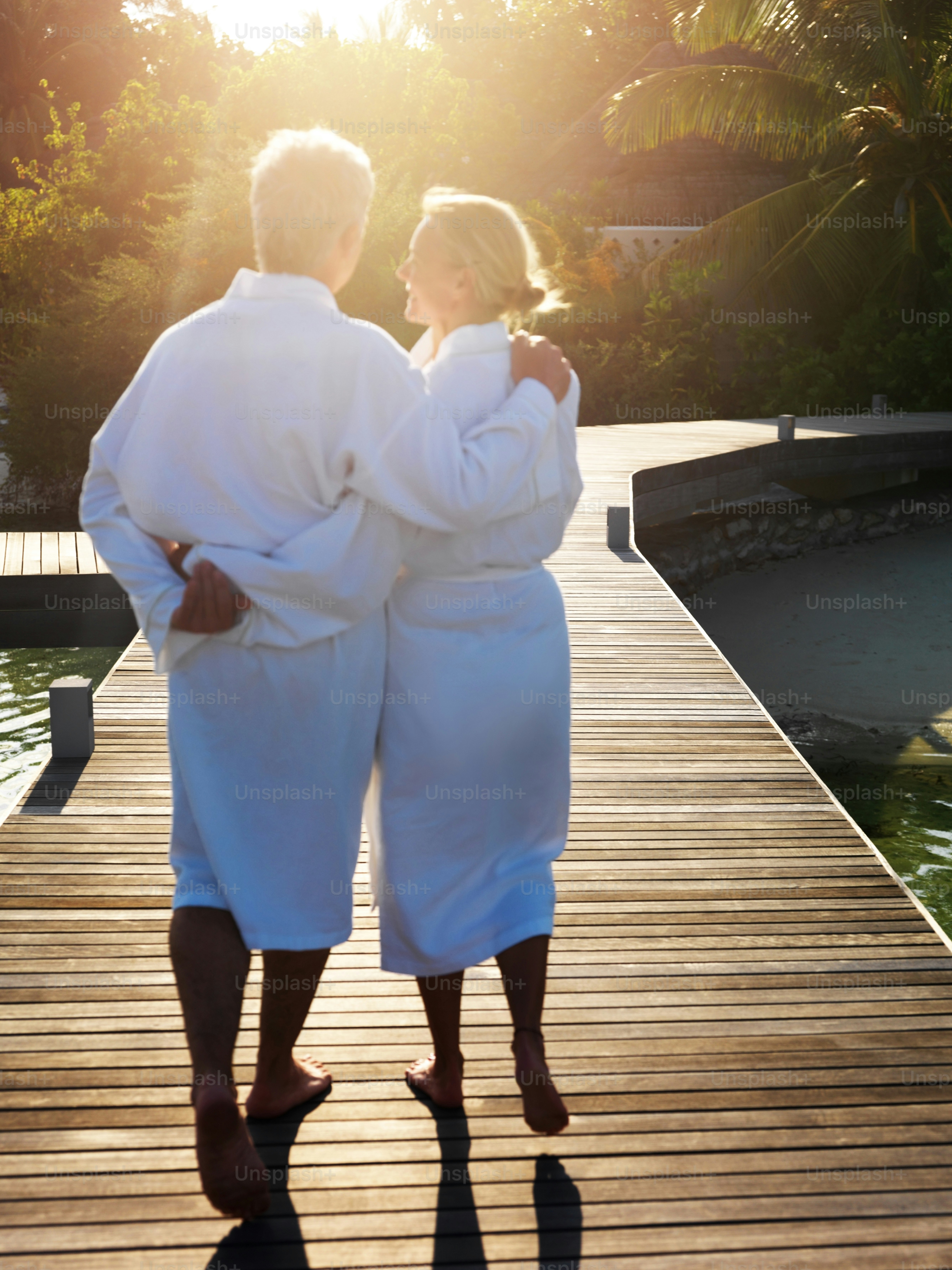 Couple enjoying romantic getaways at a luxury beachfront resort during sunset