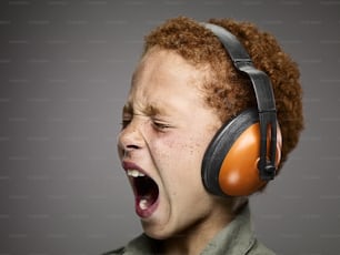 a young boy wearing a pair of headphones