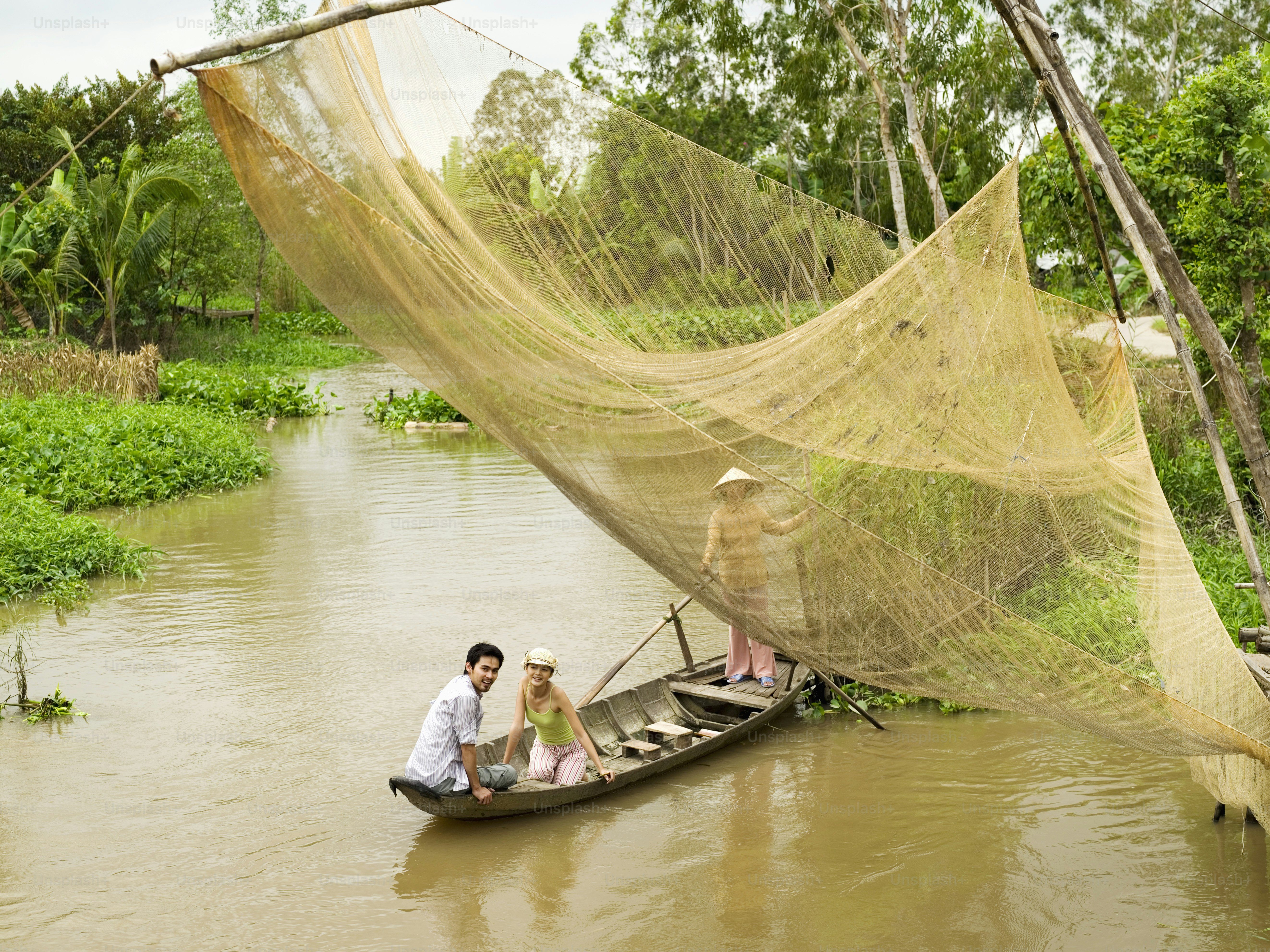a man and a woman in a small boat on a river