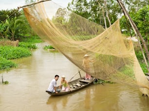 a man and a woman in a small boat on a river