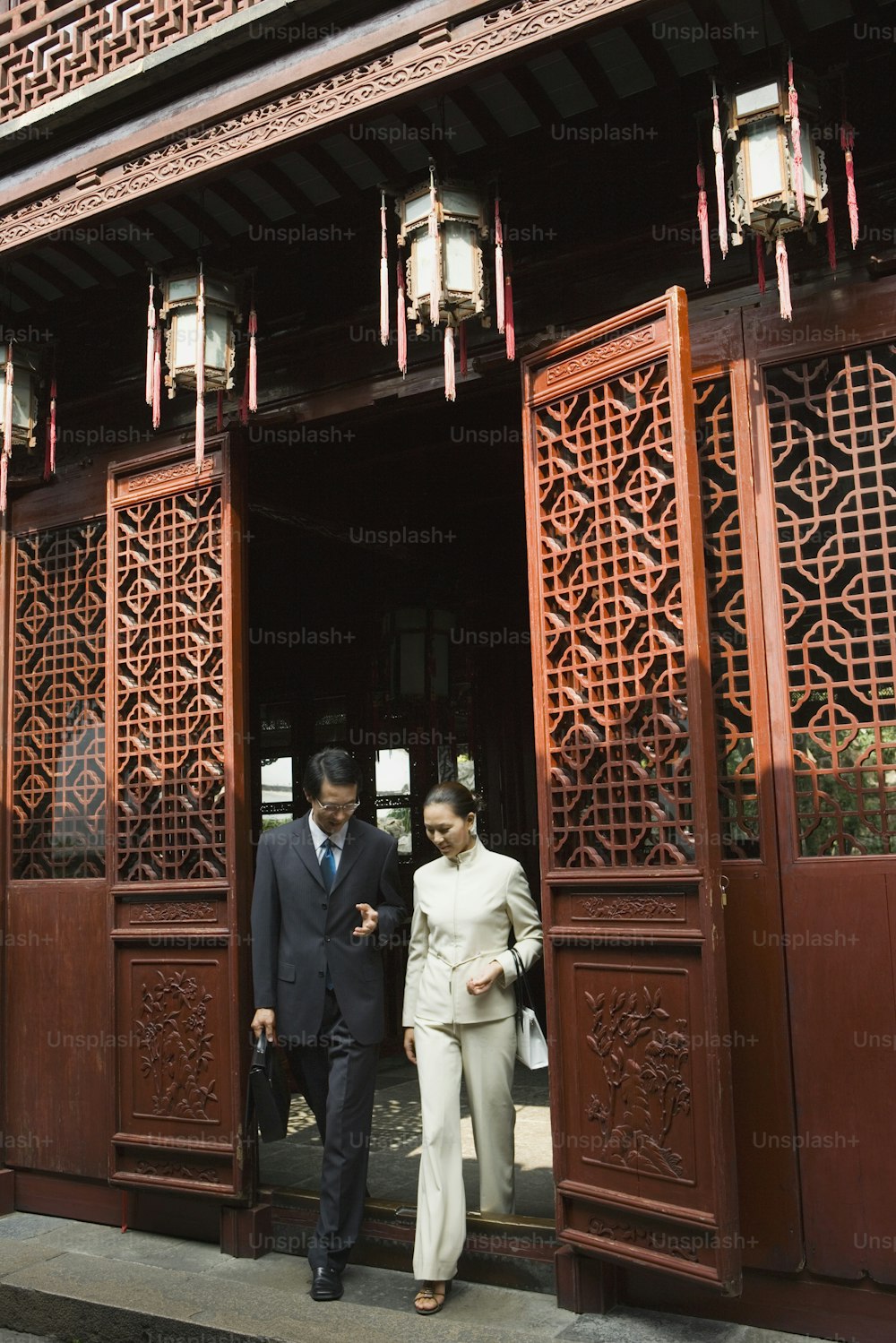 a man and a woman standing outside of a building