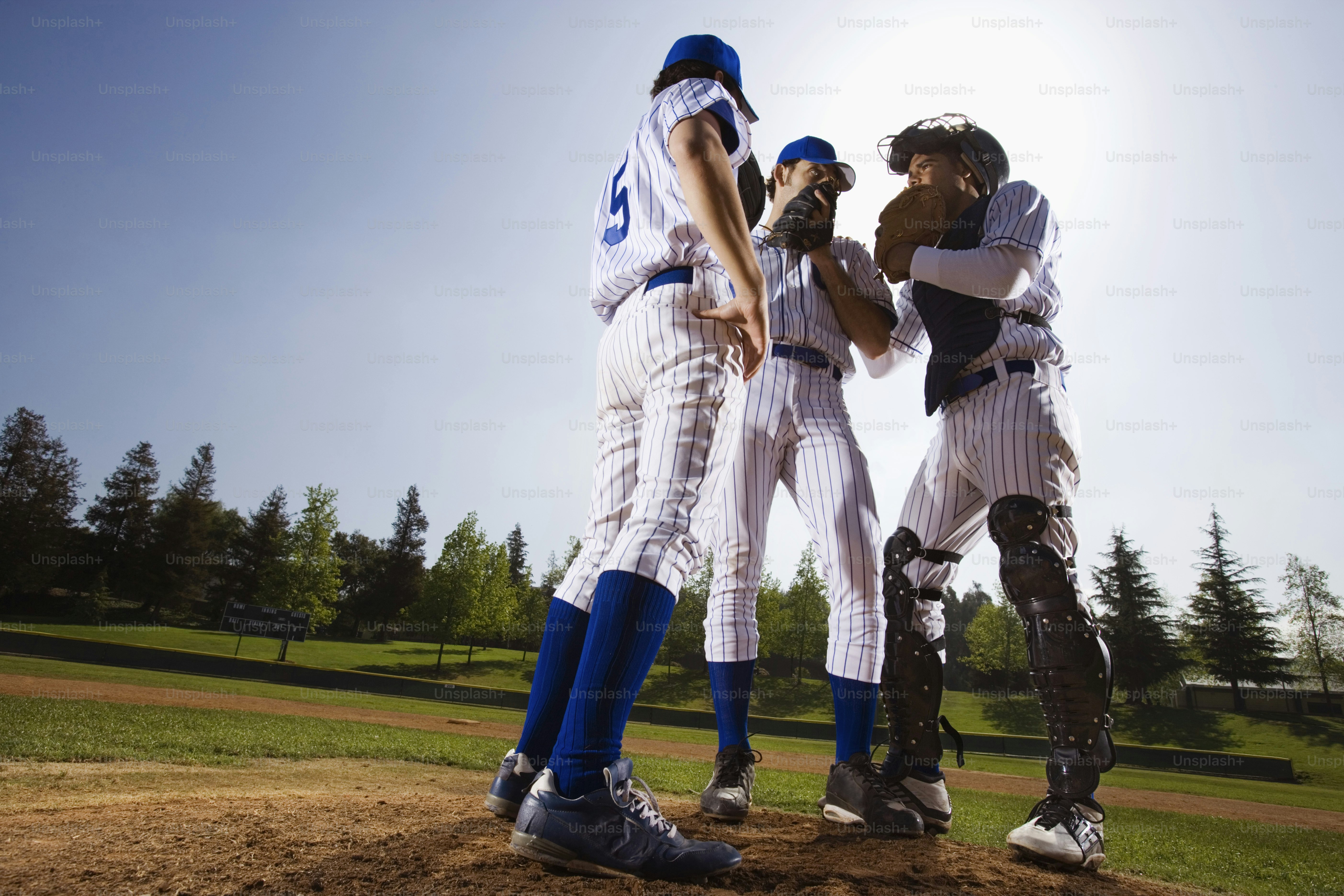 a group of baseball players standing on top of a field