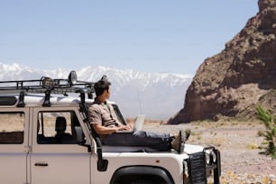 a man sitting on top of a white truck