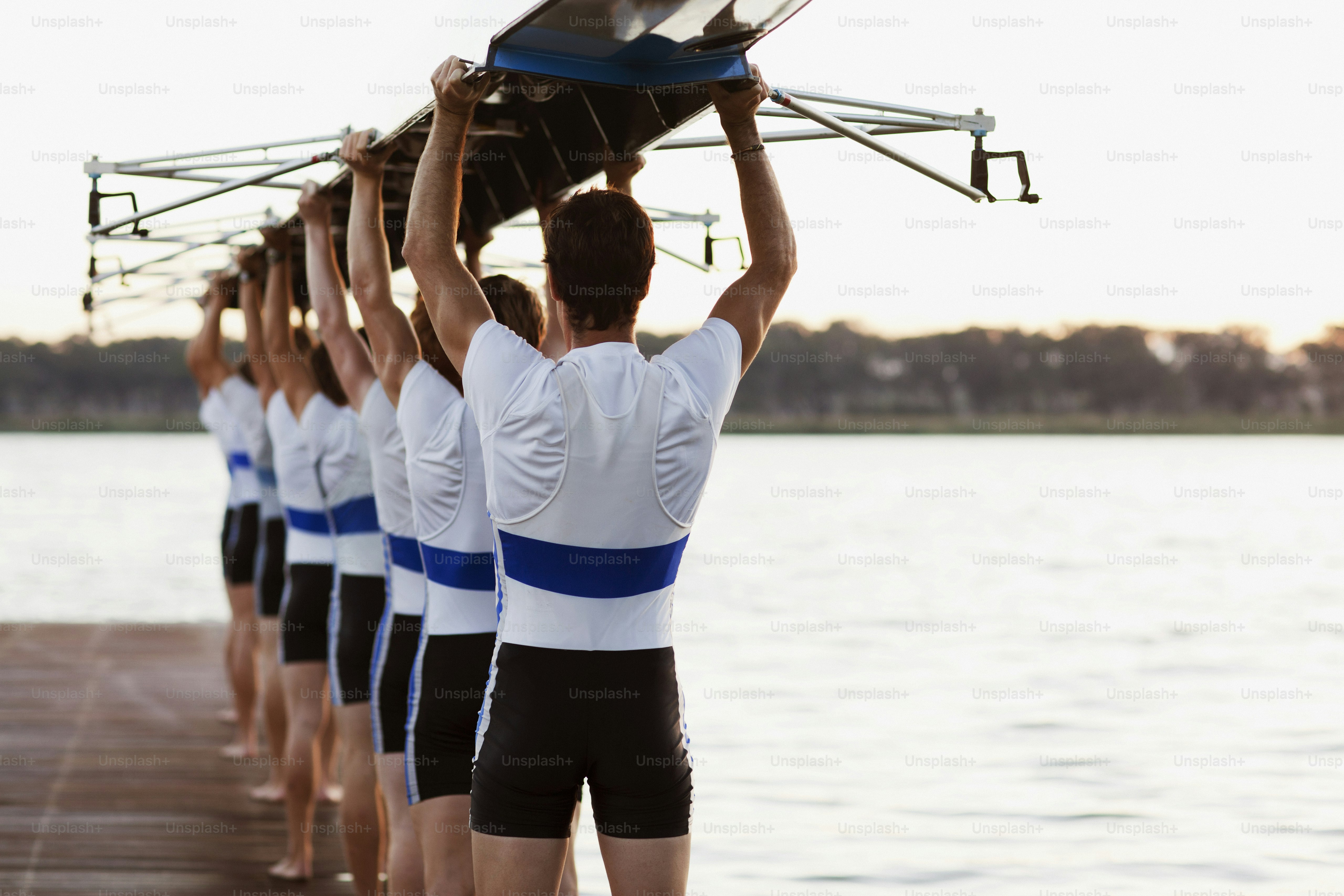 a group of men standing next to each other on a pier