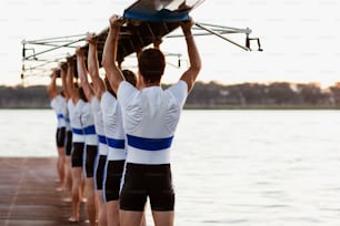 a group of men standing next to each other on a pier