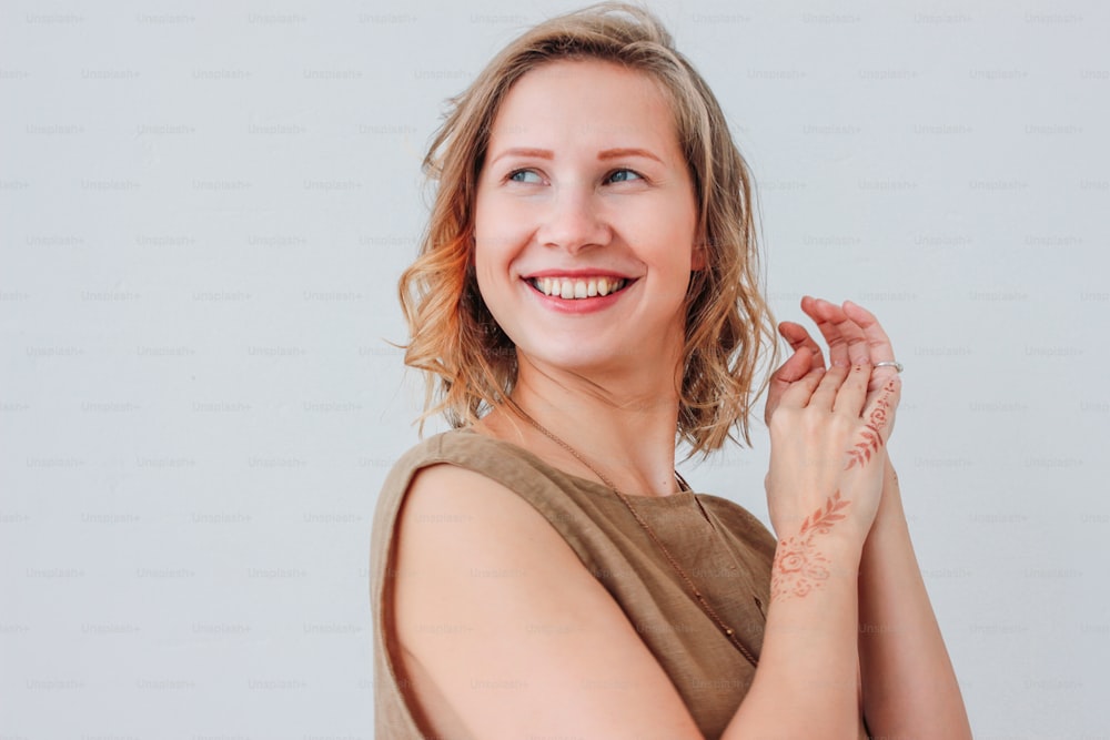 Portrait of beautiful charming young woman in linen dress with mehendi on hands, eco natural beauty, isolated on white background