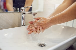 Washing hands rubbing with soap man for corona virus prevention, hygiene to stop spreading coronavirus.