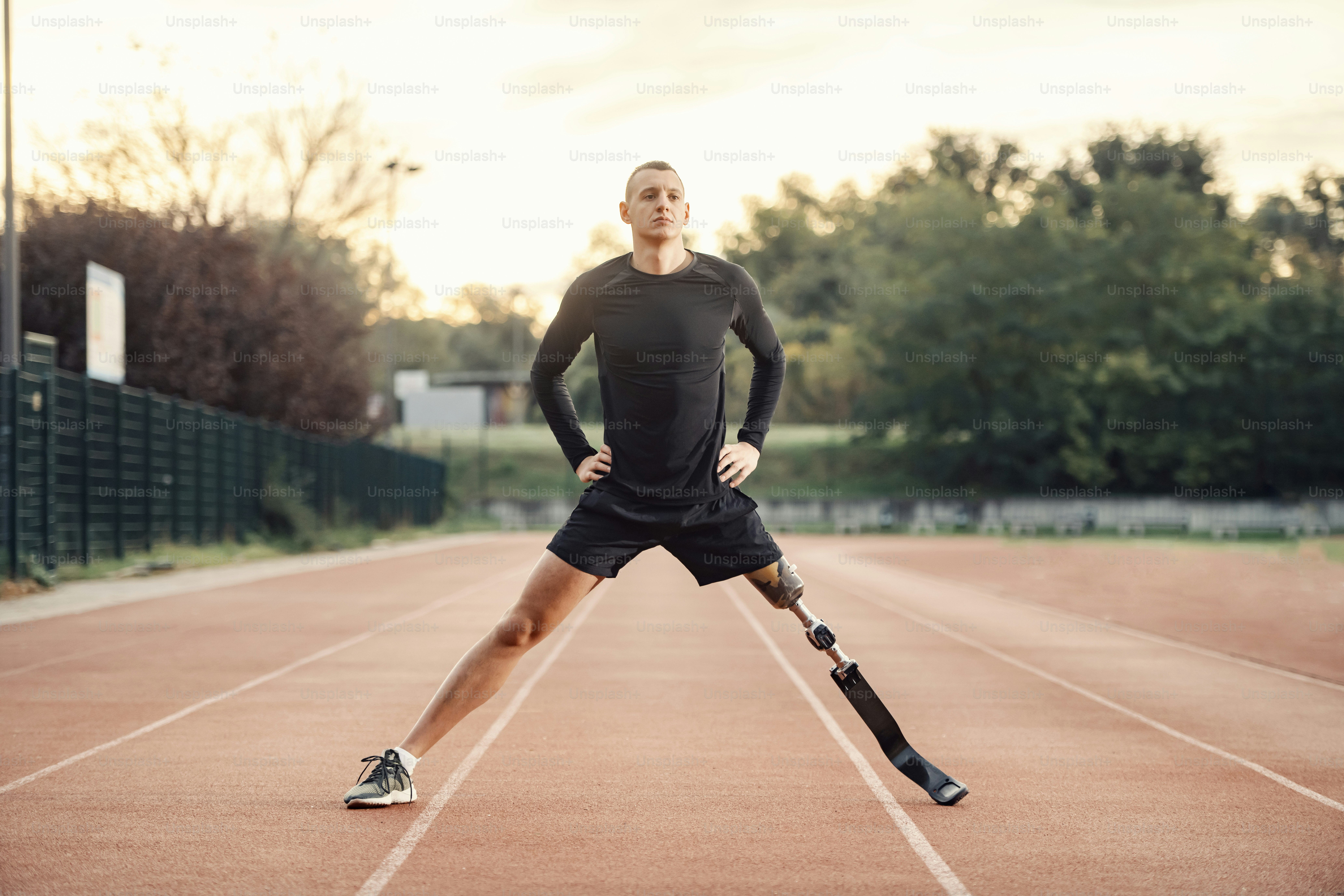 A fit sportsman with prosthetic leg workout at stadium.