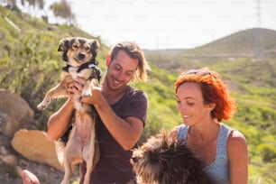alternative outdoor living lifestyle family and couple in friendship and relationship have fun with their two dogs. happiness together in outdoor leisure activity. nature country side