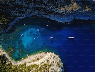 Aerial shot of beautiful blue lagoon at hot summer day with sailing boat. Top view.