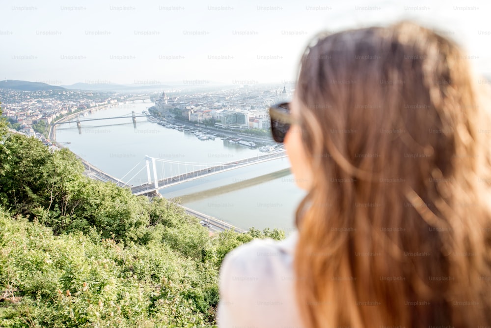 Woman enjoying landscape aerial view on the Budapest city during the morning light in Hungary