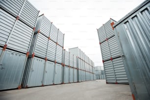 Spacious container storage area with stacking shipping containers under open sky at distribution warehouse