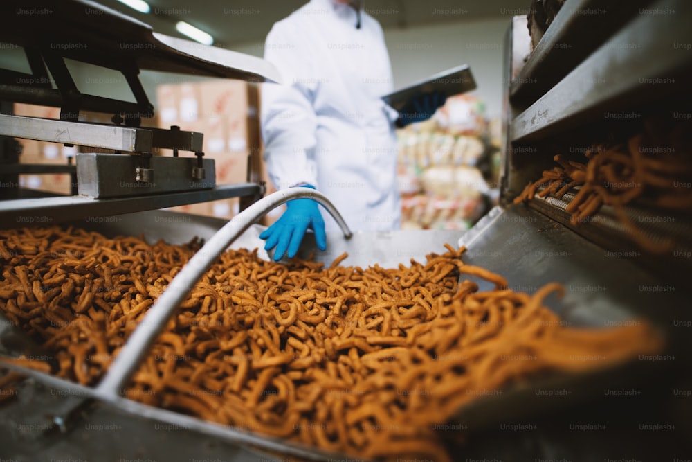 Close up of salty snacks in factory production line.